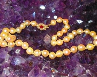 Strand of Baroque cultured pearls with 14 karat gold and ruby clasp, total weight 22.4 dwt