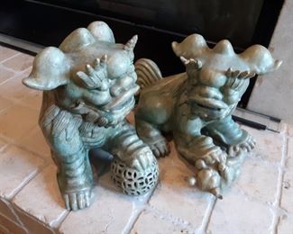 Pair of Celadon foo dogs slight damage to a tip of an eyebrow