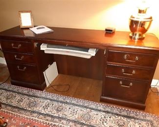 Another large mahogany desk not as deep as the other
