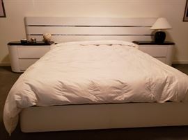 Queen size bed with 9 feet wide headboard and a pair of two drawer nightstand with black laminate tops