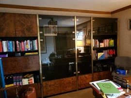 Four section wall cabinet with smokey glass doors, open shelves and drop-front desk fitment