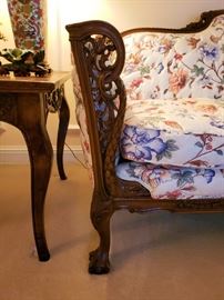 Close up of the carved mahogany frame on sofa