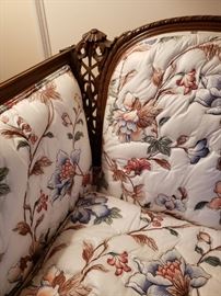 Close up of the carved mahogany frame on sofa