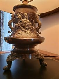Oriental style metal desk lamp with birds on one side and turtle on the other