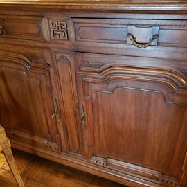 Close up of the base of mahogany cupboard