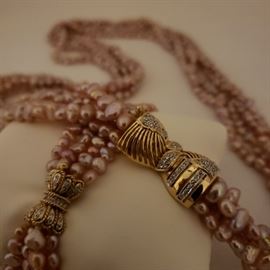 Four strand pink freshwater pearl necklace with matching bracelet with 14k yellow gold and diamond clasps and spacers in bracelet