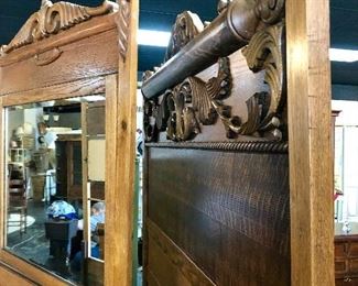 Closer view of the top of the antique oak bed and dresser