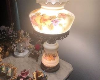 one of  several old style or Victorian in style lamps with hand painted shades. Capodimonte and other goodies on the table too