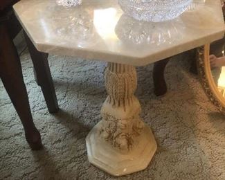 a faux marble cherub side table