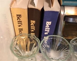 Sherbet glassware or ice cream dishes in front of cookbooks filled with great recipes