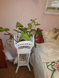 wicker plant stand and plant