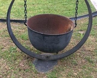 Planter made from antique wagon wheel rim, scalding pot and old disc for base.