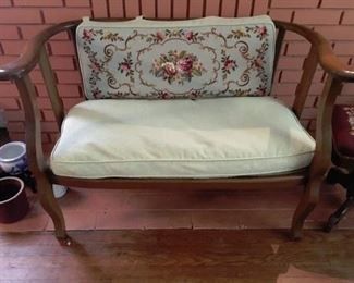 Very old antique settee.  Grandmother hand stitched design on pillow. 
