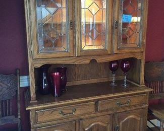 Matching oak hutch to the table, has lighted shelves and lots of storage.