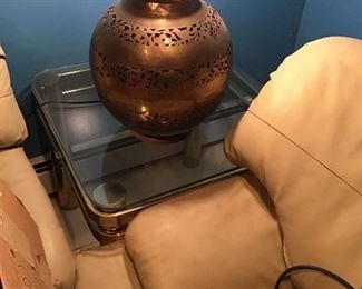 Modern leather sectional sofa, glass top end table, pierced brass lamp