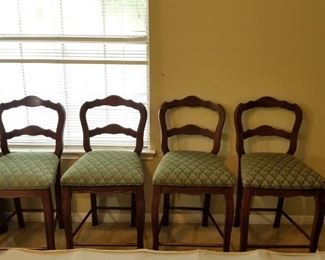 set of 4 wooden chairs with green upholstery