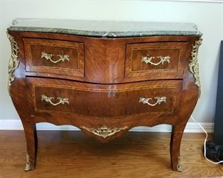 Louis XIV style chest/accent table located in dining area