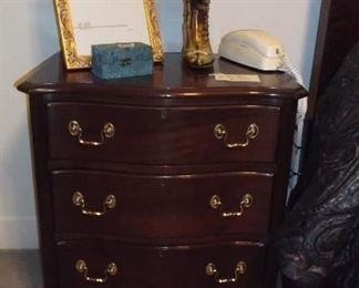 One of a pair of three drawer side tables