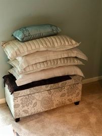 Pillows and linens, including a storage ottoman