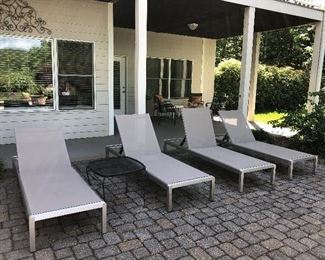 Very Nice, four sleek loungers, backs are adjustable, also have wheels on two legs for easy moving! Black metal table