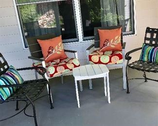 Outdoor chairs, two matching the sleek loungers and two black metal chairs