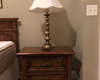 One of two matching bedside table, and one of two brass lamps.