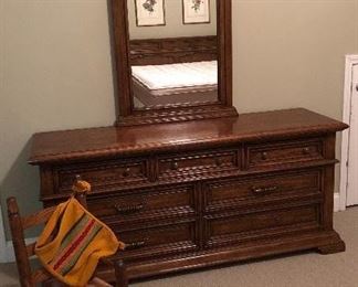 Long dresser with matching mirror, small child's rocker.