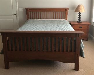 Mission style queen bed and matching side table, cute lamp.