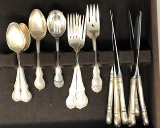6 knives, 4 forks, 4 Salad forks, 13 serving spoons, 1 pickle fork  -- Towle French Provincial Sterling Silver