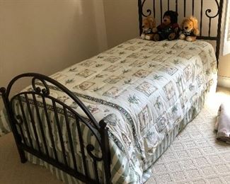Metal twin bed and Winnie the Pooh comforter
