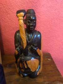 fertility god? (okay, what is that coming up out of his lap, then?)