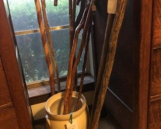 crock with whittled walking sticks
