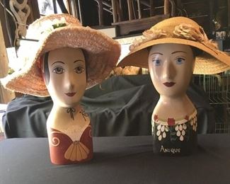 Wooden wig/hat forms with vintage hats