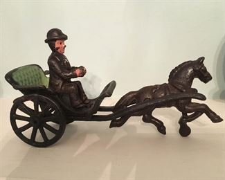 Antique cast iron man in horse drawn carriage