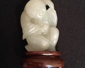 Jade Asian figurine on wooden stand