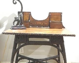 Wicker writing desk; bronze monkey lamp