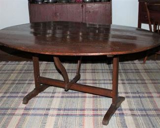 Antique 19th Century Oval Tilt-Top (60” x 44”) table and tilts to a vertical position so it may be stored against a wall when not used.