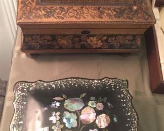 Close up of antique Victorian boxes - top one has marquetry decoration with castle scene, the other has mother of pearl inlay