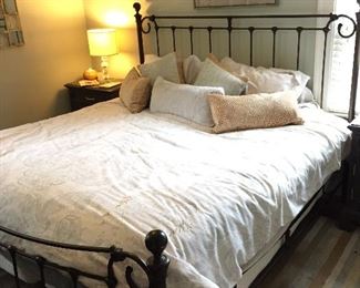 King-size metal bed frame with foundation; and wall decor