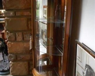 Illuminated corner curio cabinet.