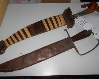 Two long knives. One very ornate.