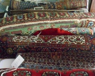Twelve hand knotted rugs in various sizes.
