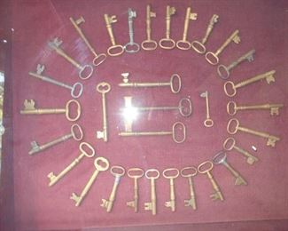 Brass key collection in case.