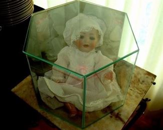 Doll in display case.