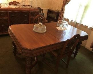 Table with leaf that stores underneath. Sturdy Table and 6 chairs.