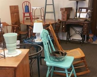 painted chairs, old stools, treadle sewing machine, old sewing machine drawers, maple dining room table and chairs, mirrors