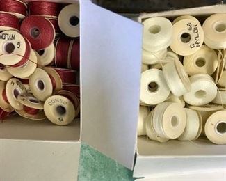 Boxes of threaded bobbins in primary colors
