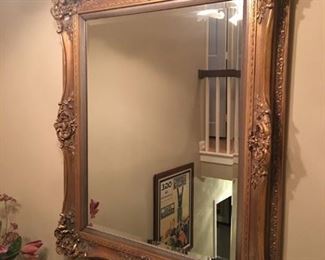 Antique beveled wall mirror with ornate gold gilded frame