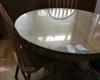 round oak table and 4 chairs.  Glass top. Also nice Oak dining table with leaf and 6 chairs