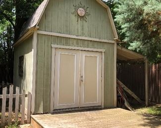 10' x 12' Storage Building with 1 1/2 stories and double door entry.  Attached lean-to cover and entry platform.  